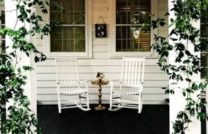 Two rocking chairs in front of a home