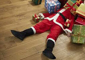 Santa Lying Under Presents